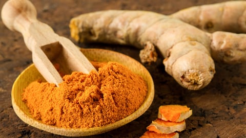 Turmeric root and turmeric powder on wooden background; Shutterstock ID 370061894