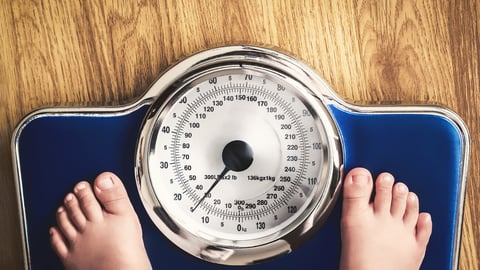 kids feet on weight scale; Shutterstock ID 425756197
