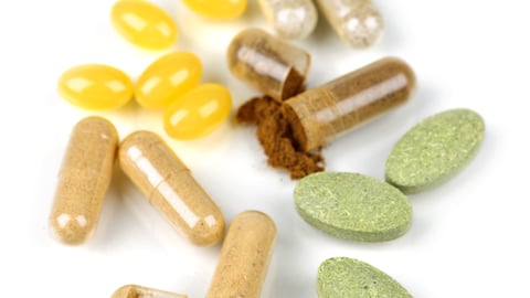 Mix of  herbal supplements and vitamin pills isolated on white; Shutterstock ID 45600142