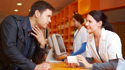 Customer with flu in pharmacy talking to a pharmacist; Shutterstock ID 87041267
