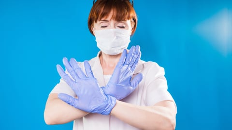 Upset healthcare worker making a cross with her hand