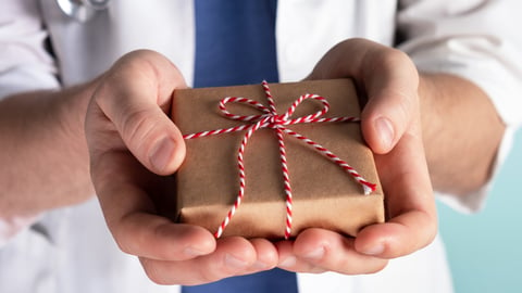 Doctor holding small gift