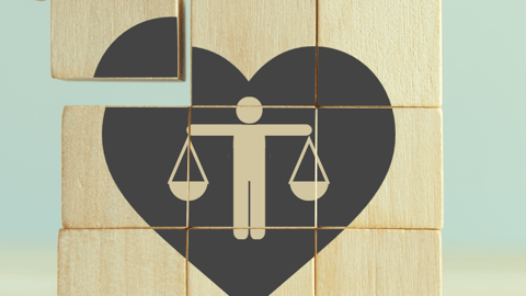 wooden blocks showing a heart with a person and balance scales