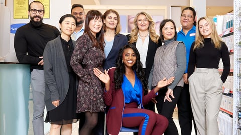 A team of coworkers smiling for a group photo