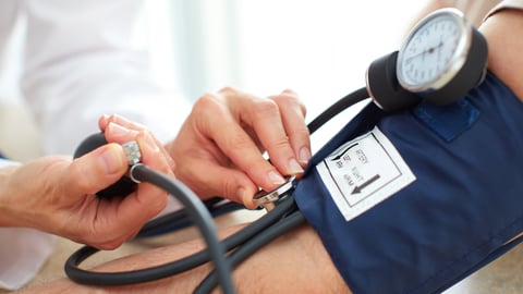 Patient getting their blood pressure taken by a doctor