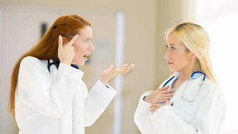 two-women-doctors-in-white-talking