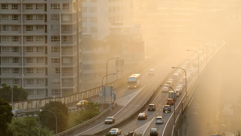 overpass highway showing cars and yellow, smoggy air