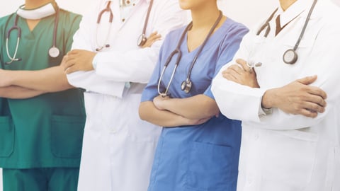 Four doctors crossing their arms are seen in this stock image. (Shutterstock)