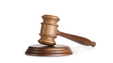 A wooden judge’s gavel on a white background