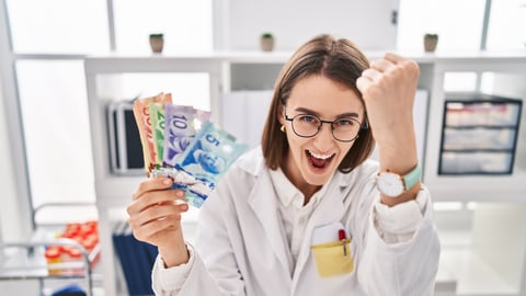 A doctor is seen celebrating while holding cash.