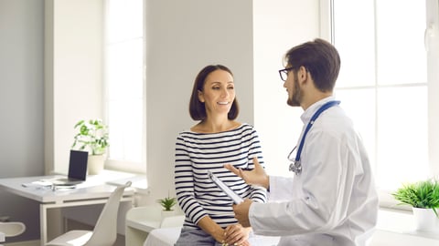 A woman speaks to her family doctor.