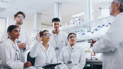 Medical students at a lab with a professor.