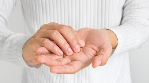 person holding their sore or numb hands together