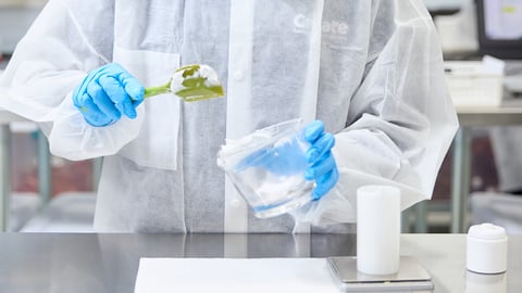The hands of a pharmacist working in compounding medications