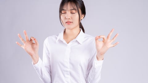 Young asian woman doing breathing exercise