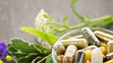 Herbs with alternative medicine herbal supplements and pills; Shutterstock ID 84576220