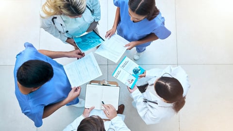 Doctor, team and documents in collaboration above in healthcare planning, meeting or brainstorming at hospital. Group of medical professionals with paperwork in teamwork, strategy or ideas at clinic; Shutterstock ID 2282908649