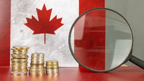 Magnifying glass and coins in front of Canada flag, country economy concept; Shutterstock ID 1800187600