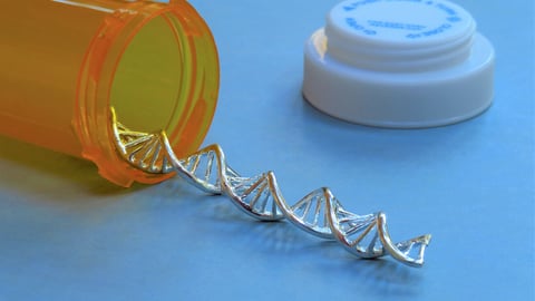 Closeup of a  silver DNA strand spilling out of an orange prescription bottle on a blue background.; Shutterstock ID 1833531112