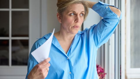 Menopausal Mature Woman Having Hot Flush At Home Cooling Herself With Letters Or Documents; Shutterstock ID 2281774383