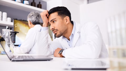 Scientist, stress and headache for computer research, planning and data analysis, mistake or healthcare results. Sad or tired science man or doctor working on laptop in medical or medicine laboratory; Shutterstock ID 2360731375