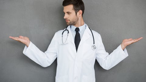 In search of right medical solution. Handsome young doctor in white uniform stretching out his arms while standing against grey background; Shutterstock ID 311397764