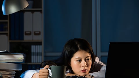 Image of sleepy doctor with coffee working at office tired after busy day night shift trying to stay awake. mixed race asian chinese woman model; Shutterstock ID 549638269