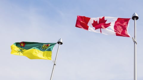 Saskatchewan and Canada flags against blue sky. Regina, Saskatchewan, Canada.; Shutterstock ID 673522303