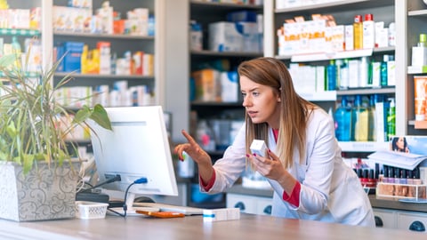 Portrait of pharmacist standing at counter in pharmacy. Pharmacist using the computer at the pharmacy. Medicine, healthcare and technology concept ; Shutterstock ID 1385081495