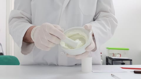 A pharmacist making a cream in the pharmacy laboratory; Shutterstock ID 1411662008