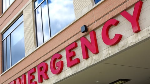 Red emergency room sign on the side of hospital with windows; Shutterstock ID 146467091