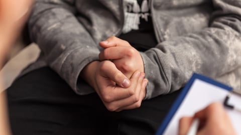 Young teenager boy uncomfortable at counseling - close up on clutching hands; Shutterstock ID 1524470642