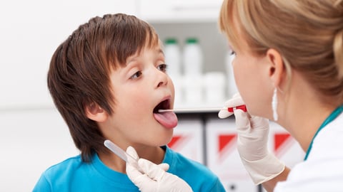 Boy at the doctor - a healthcare professional taking biological samples for testing; Shutterstock ID 171306479