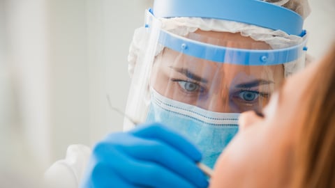 Young female dentist curing patient's teeth filling cavity. Stomatologist working with professional equipment in clinic office. Close-up shot, teeth care and medicine concept; Shutterstock ID 1723241299