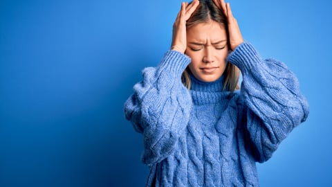 Young beautiful blonde woman wearing winter wool sweater over blue isolated background suffering from headache desperate and stressed because pain and migraine. Hands on head.; Shutterstock ID 1920373304