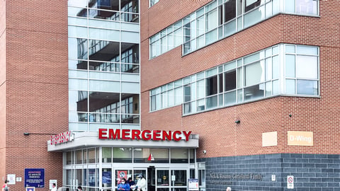 Richmond Hill, Ontario, Canada - May 18, 2021 : Emergency room entrance of Mackenzie Health hospital in York region. Patients and seniors wearing protective mask under covid-19 omicron variants spread; Shutterstock ID 1976295602