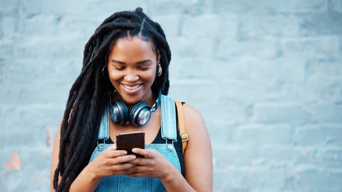 Black woman with 5g smartphone for social media typing, digital chat app or check location on blue wall background space mockup. Teenager gen z girl on cellphone for youth online website networking; Shutterstock ID 2211548835