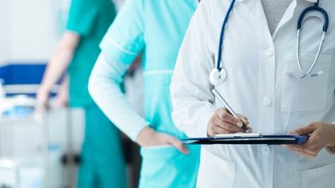 Medical staff working at the hospital: doctor and nurse checking a patient's medical record on a clipboard, healthcare and medical exams concept; Shutterstock ID 772546597