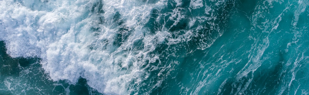 a person riding a wave on a surfboard in the ocean