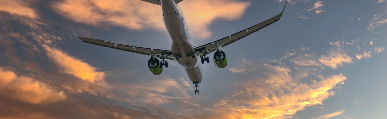 a large passenger jet flying through a cloudy blue sky