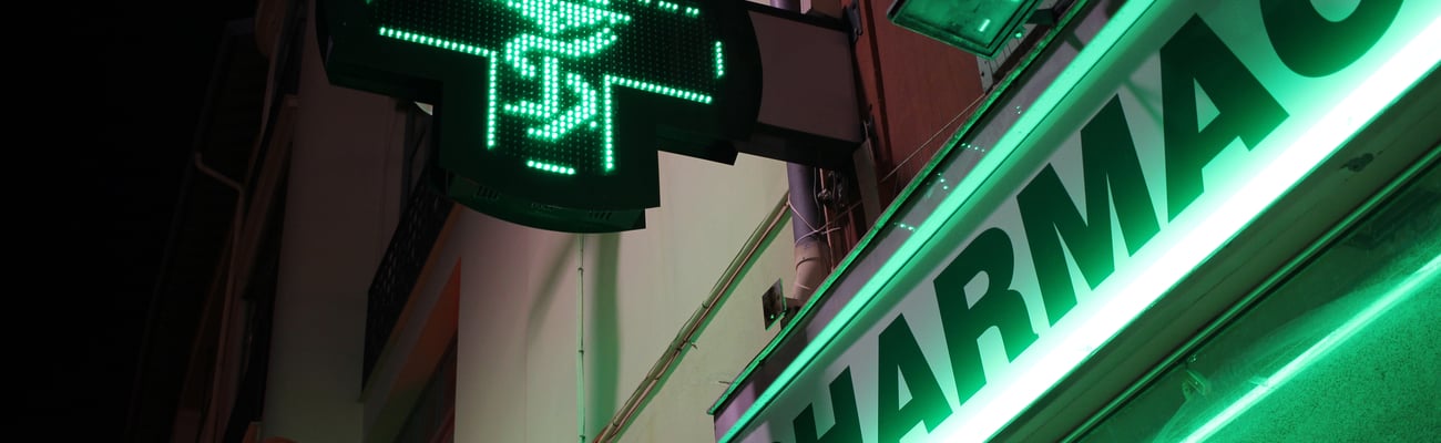 a sign on the side of a building with a green light