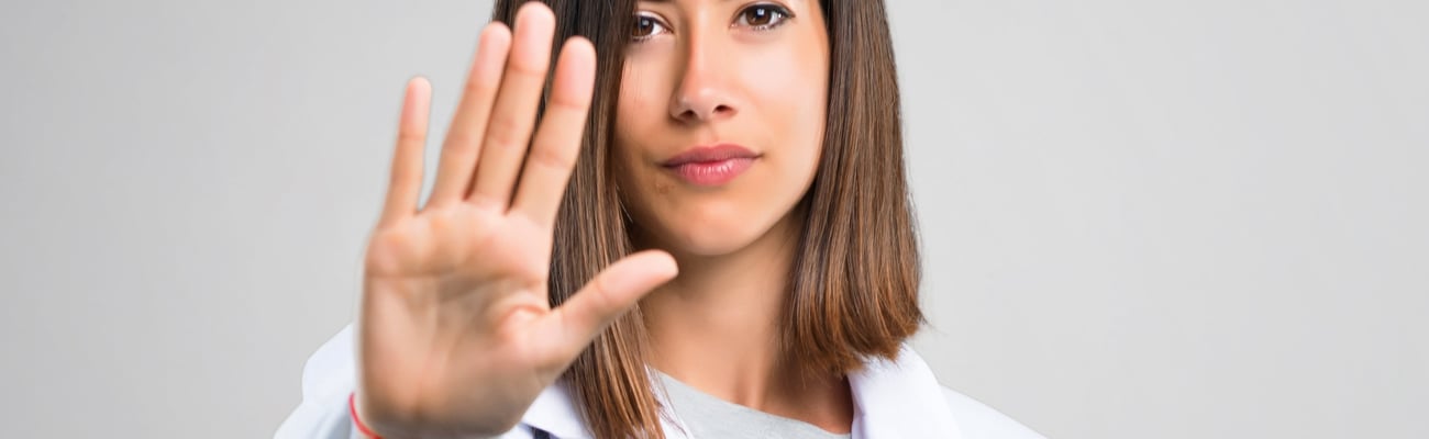 hand outstretched of female healthcare worker indicating stop