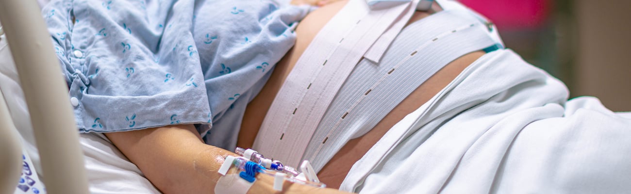 A woman in labour, giving birth in the hospital.