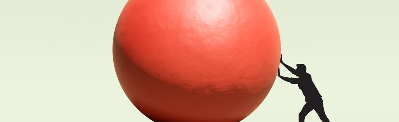 Man pushing red ball 