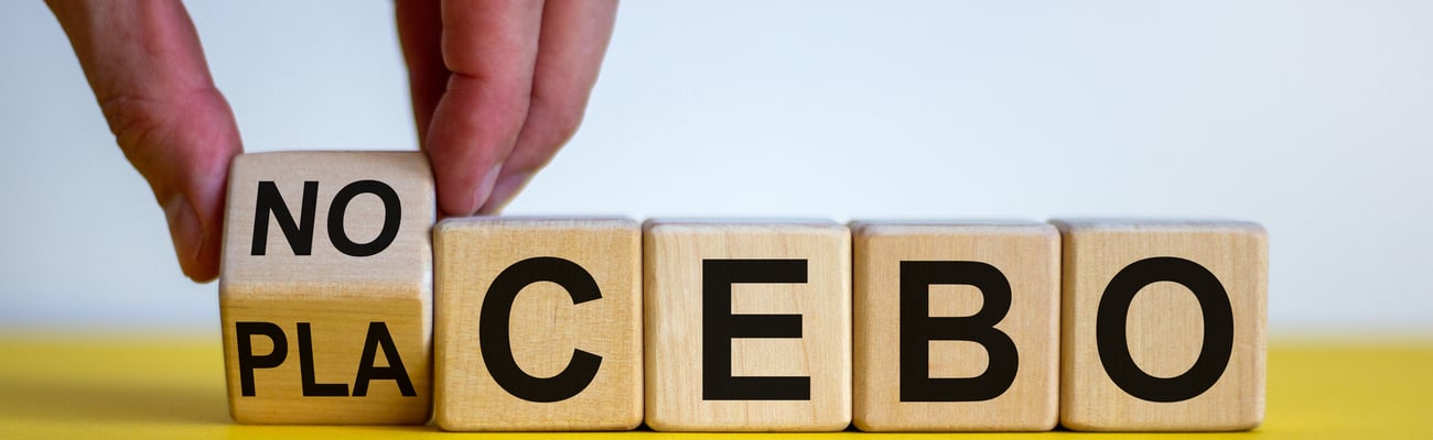 blocks spelling placebo with fingers turning a block to spell "nocebo"