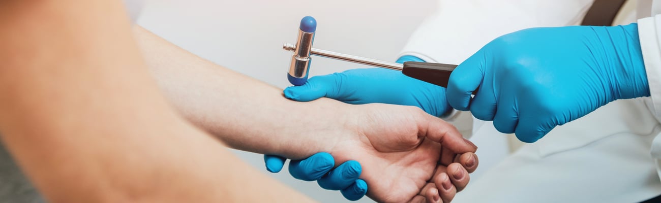Family doctor examining older patients joints