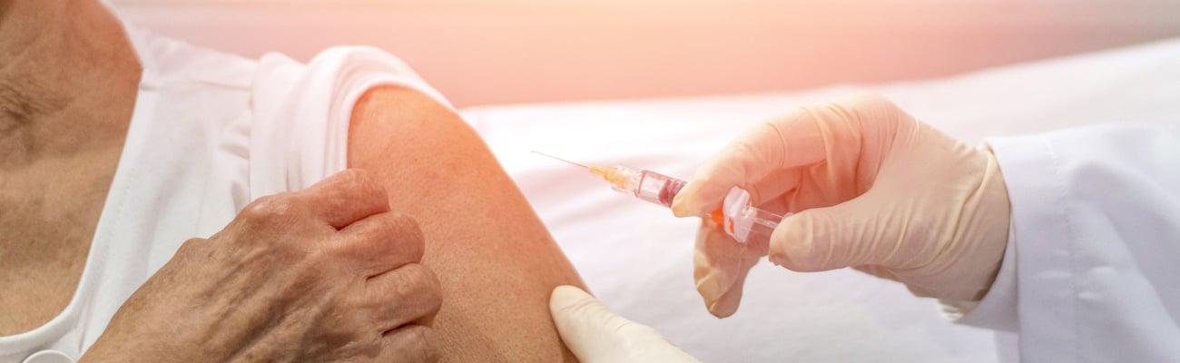Older woman receiving a vaccine