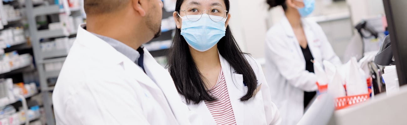 PharmD student talking to a pharmacist on her practicum. 