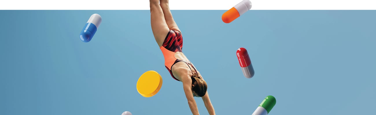 Cartoon of a woman diving into water surrounded by large pills