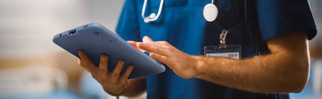 Healthcare worker using a tablet.
